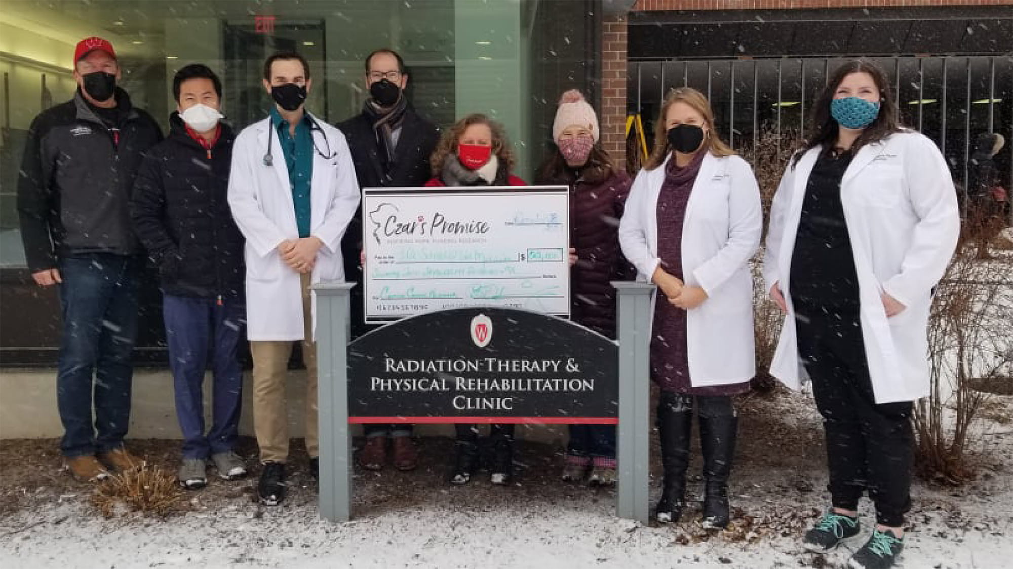 Veterinarian group photo with charity check